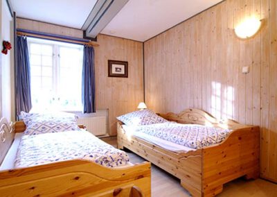 Schlafzimmer mit zwei Einzelbetten in der Ferienwohnung F1 Haubarg & Remise St. Peter-Ording