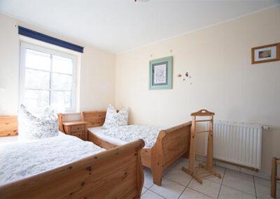 Schlafzimmer mit zwei Einzelbetten in der Ferienwohnung R1 Haubarg & Remise St. Peter-Ording